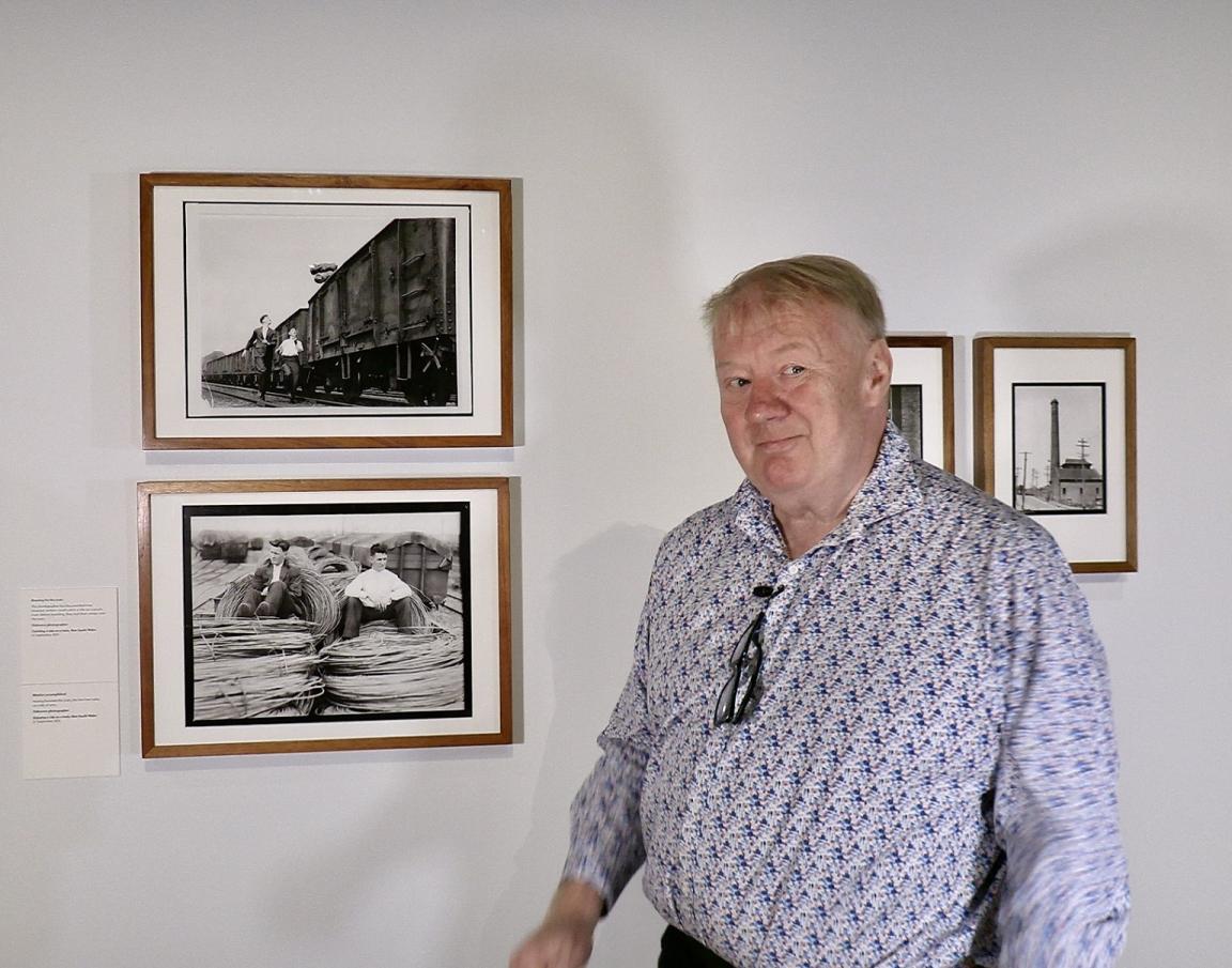 Mike Bowers standing in the 'Fit to Print' exhibition gallery