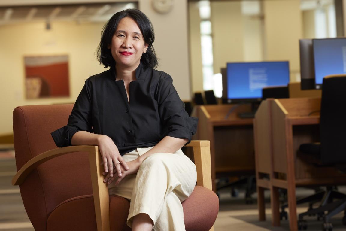 Rima Febriani sitting on an armchair in the Main Reading Room