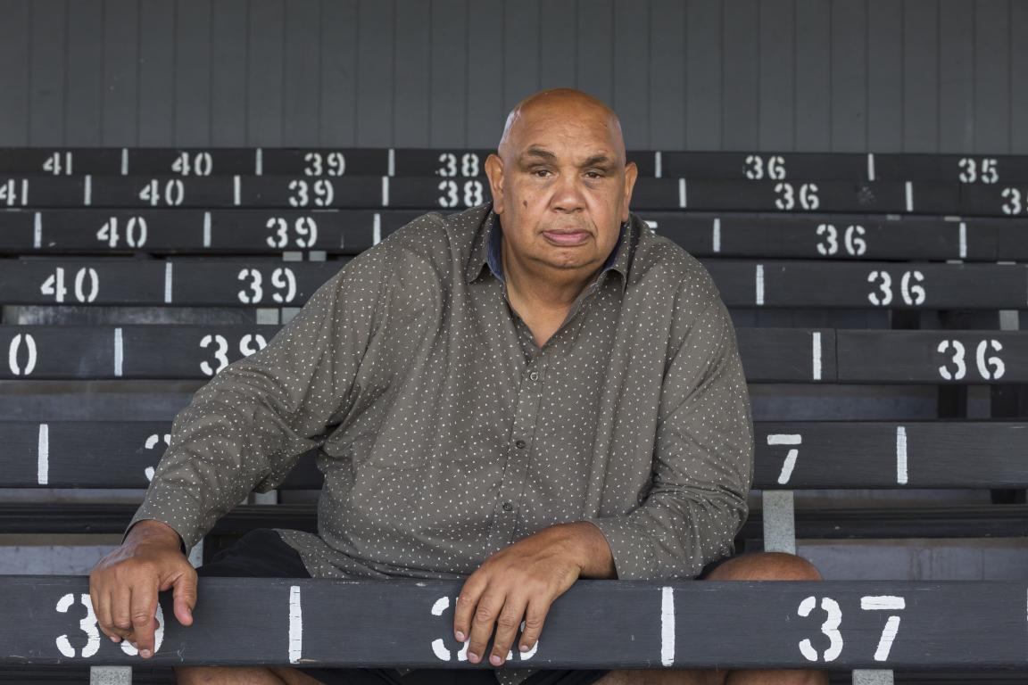 An man sits in an empty grandstand