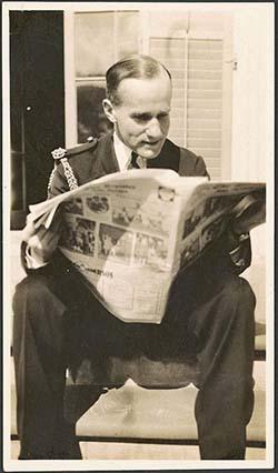 A man sitting and reading a newspaper