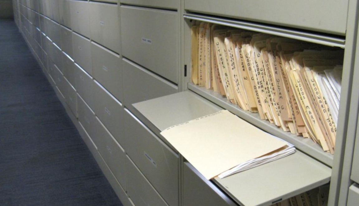 Files of newspaper clippings in a cabinet