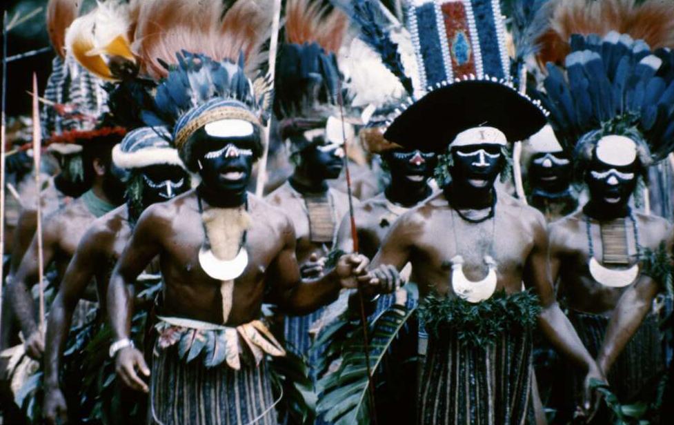 Group of Papua New Guineans in traditional dress, including feathered headpieces, at the Independence Day Celebration.