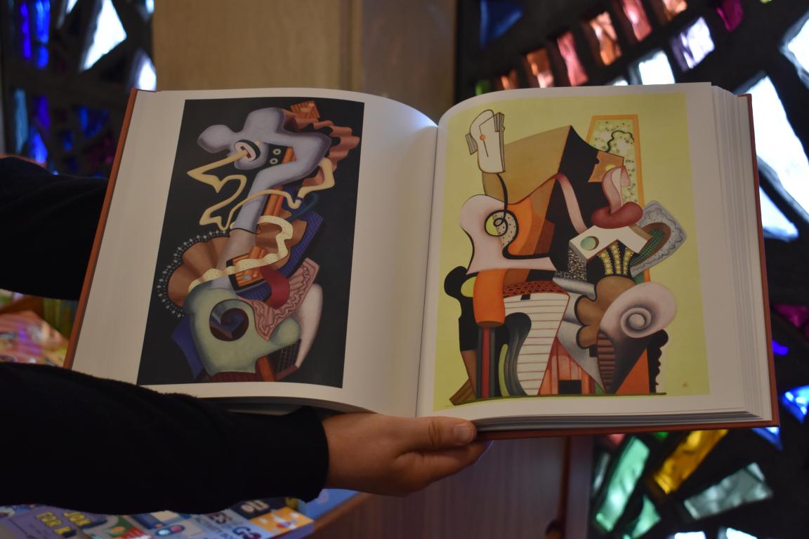An open book showing two abstract artworks by JW Power