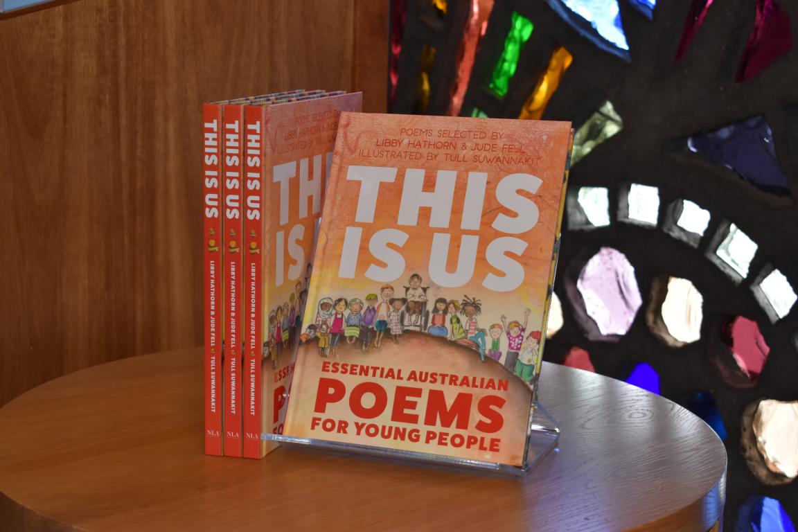 A stack of books with illustrated children on the cover and large red and white lettering