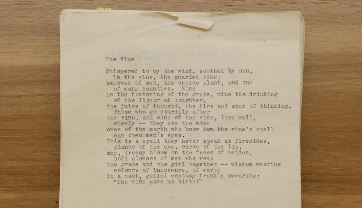 Pile of old papers, the top of which has type-written poem 'The Vine' 