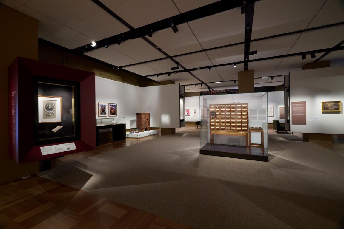 A photograph of the Library’s Treasures Gallery. The William Shakespeare display is on the left-hand side of the image. The Fred Ward card catalogue is on the right-hand side of the image.