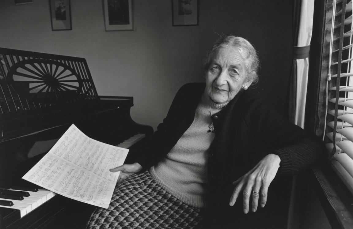 Black and white photo of Miriam Hyde sitting at a piano