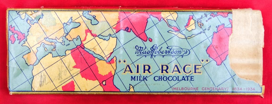 Chocolate bar in the original wrapper which features part of a world map and text reading 'MacRobertson's "Air Race" Milk chocolate'