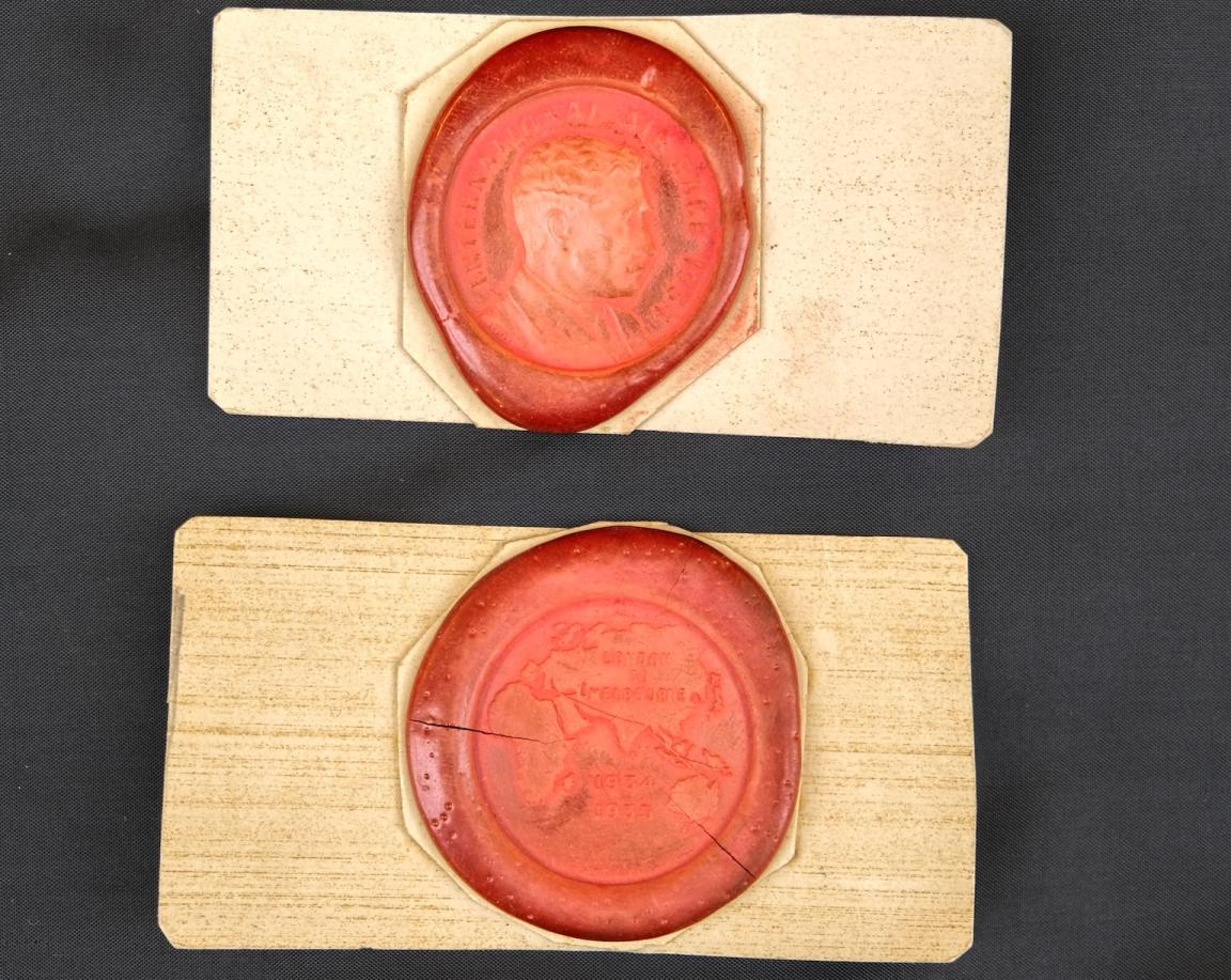 Two red wax seals, one with an imprint of Sir MacPherson Robertson and the other with a map showing Africa, Europe, Asia and Australia