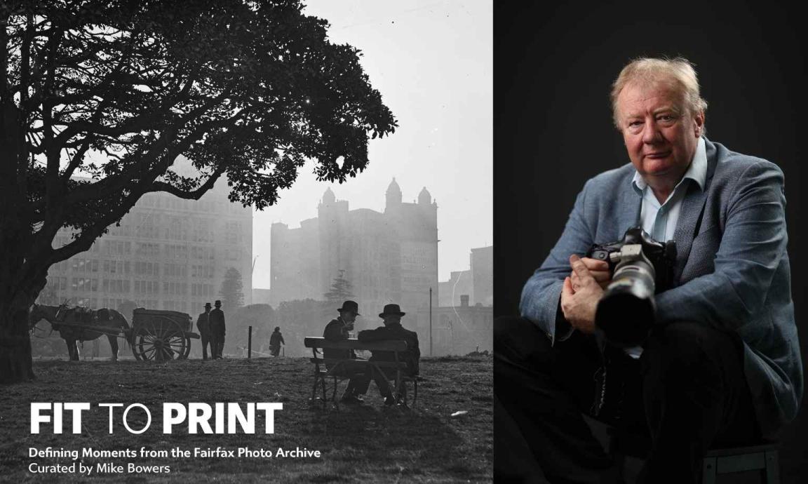 A split image: left side shows a vintage black-and-white photo of people in period attire relaxing in a park with a horse-drawn cart and city buildings in the hazy background; right side shows a modern portrait of photographer Mike Bowers holding a camera against a dark backdrop. Text at the bottom reads 'FIT TO PRINT: Defining Moments from the Fairfax Photo Archive Curated by Mike Bowers'.