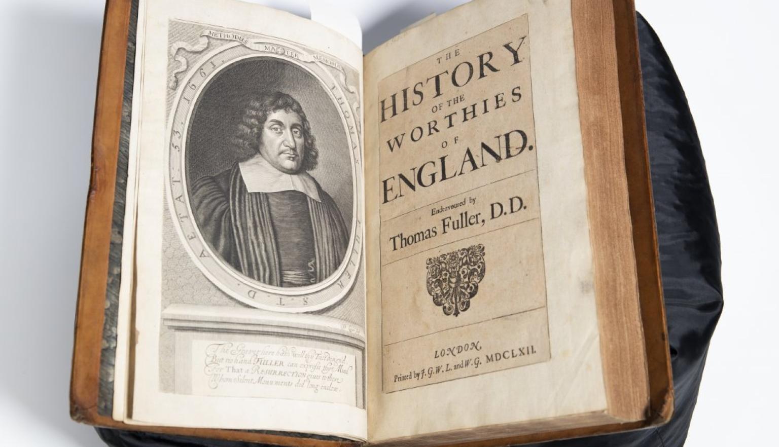 Old book open to illustrated portrait of a man and title reading 'The History of the Worthies of England'