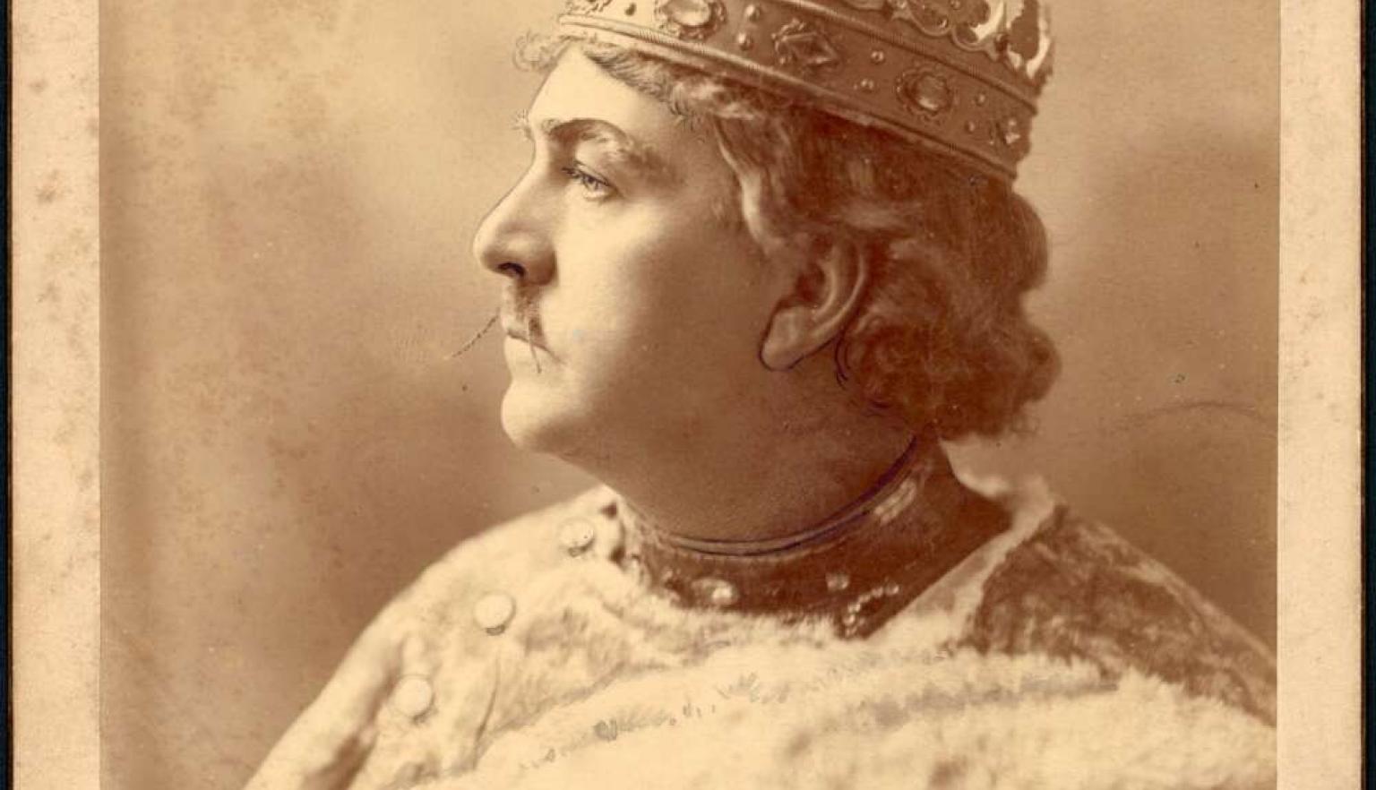 Man wearing crown and formal attire