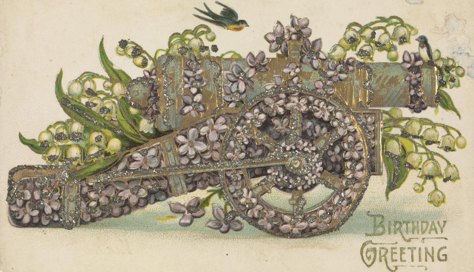 Front of an old postcard with an illustration of a cannon surrounded by purple and green flowers and the text 'Birthday Greetings'.