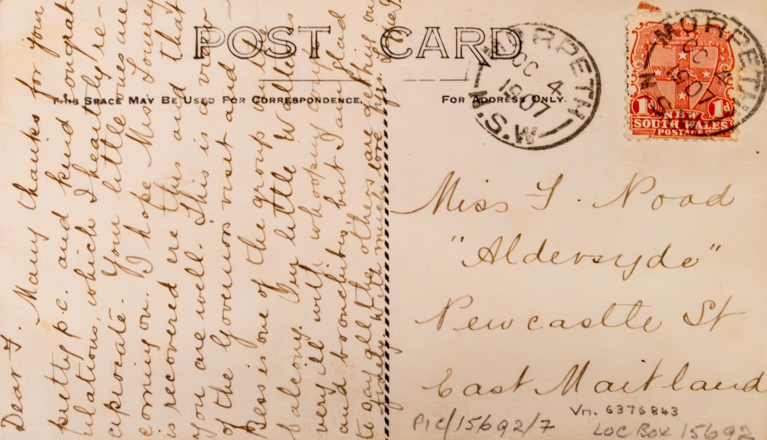 Back of an old postcard with a long message updating the recipient about the health of the sender's young family members.