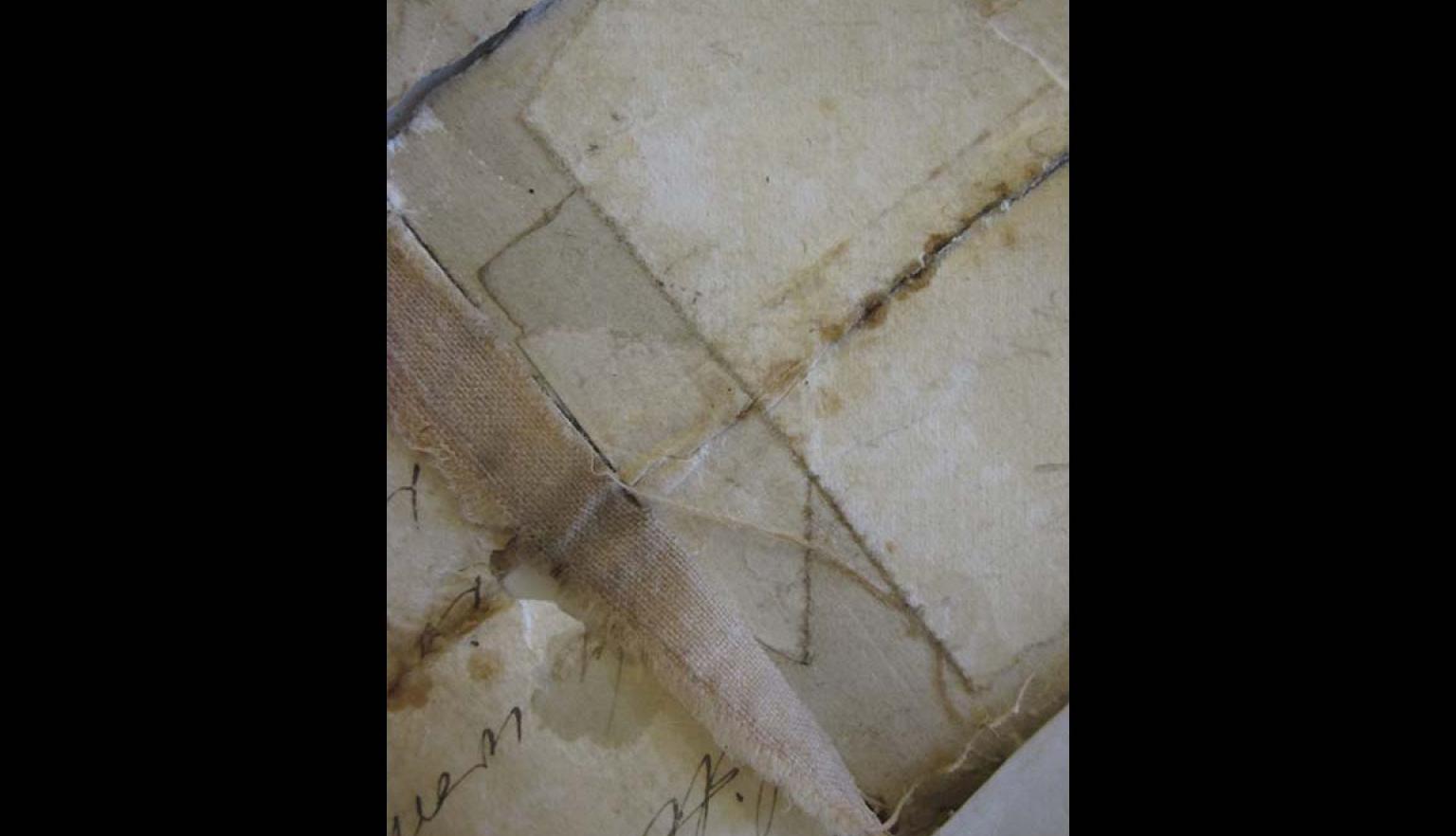 very old and damages pages with tape keeping them together, illegible cursive writing in the bottom