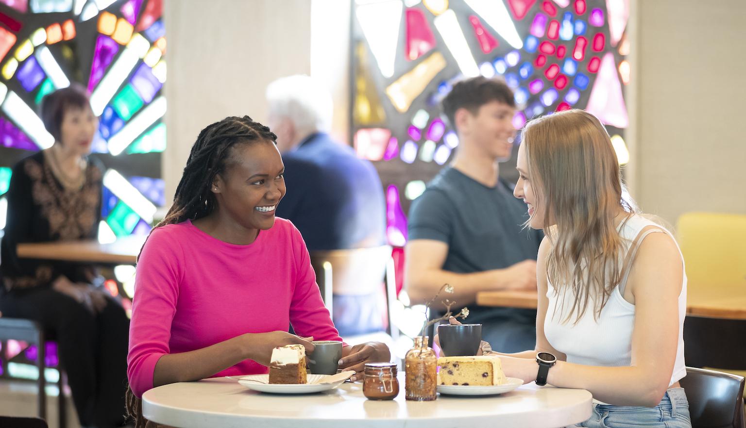 Two young women having morning tea at the Bookplate cafe