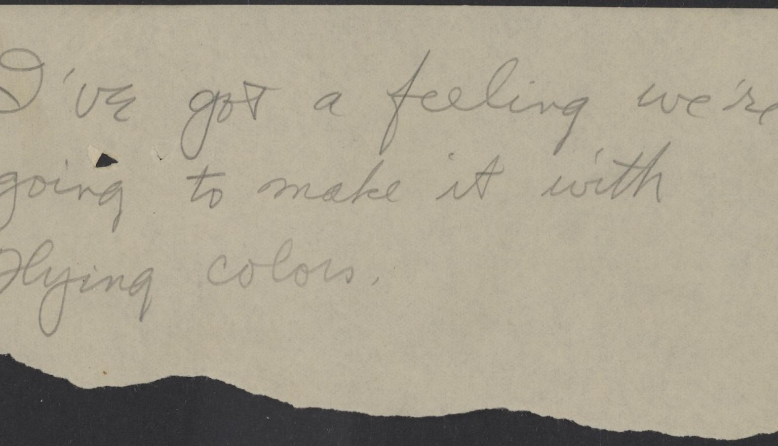 Torn piece of paper with a handwritten message reading 'I've got a feeling we're going to make it with flying colours'