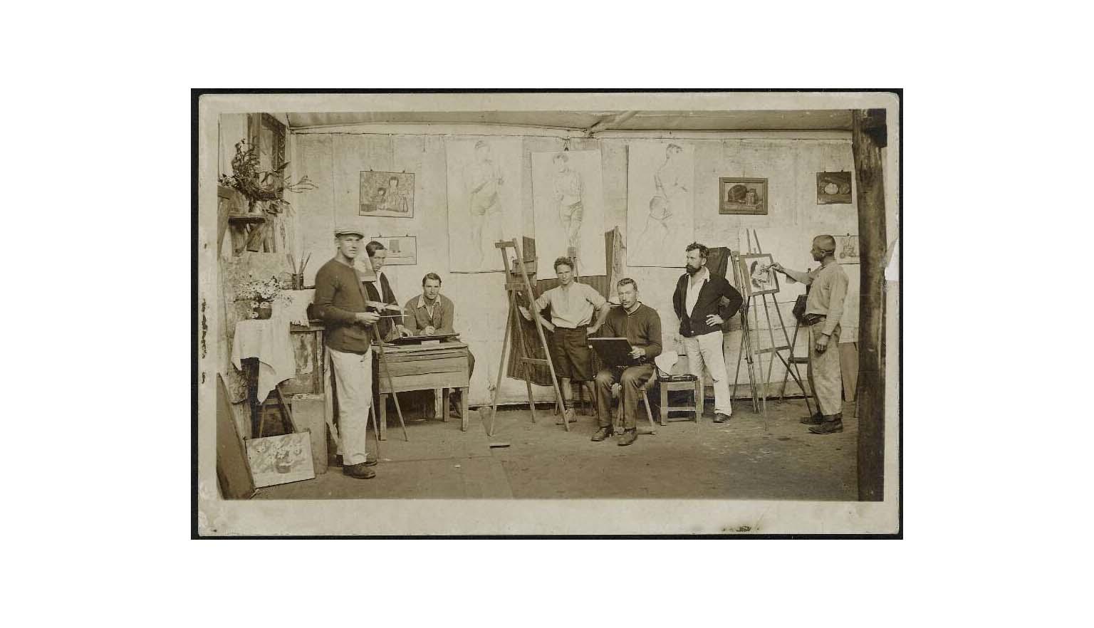 Seven men painting in an art studio