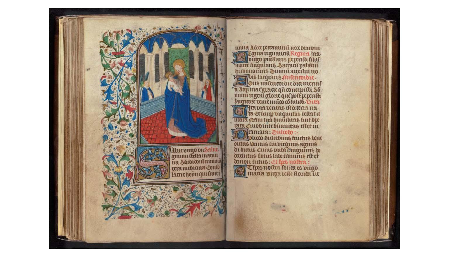 A composite image of a very old illuminated book. The left page is highly decorated and colourful. An image of a woman holding a baby is framed by plants. The right page is text written in black and red