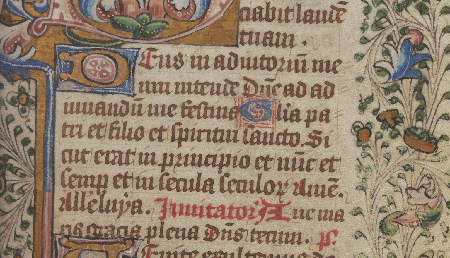 Page of an old book with latin text surrounded by a colourful decorative border