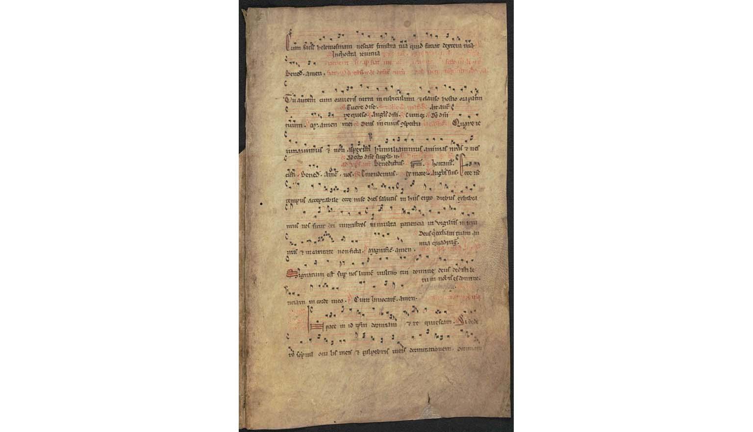 Detail view of a handwritten musical score. The lyrics are in Latin. The musical notation looks similar to modern forms with a treble and bass line clearly visible.