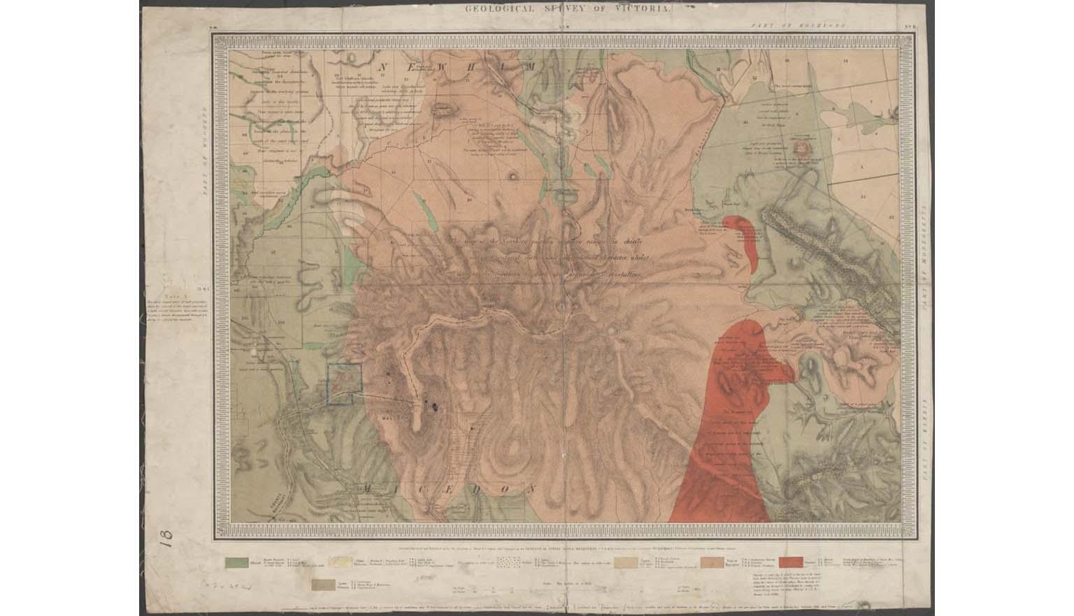 A photo of an old geological colour shaded survey map with a colour key along the bottom.