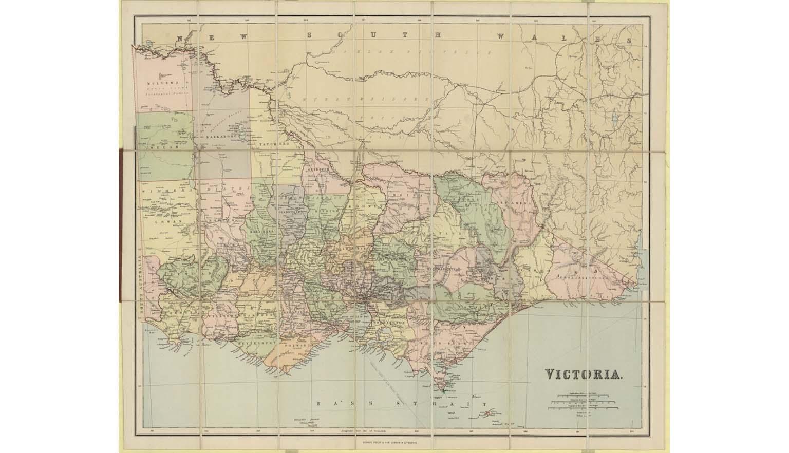 A photo of a map of Victoria with pastel colour shaded areas of green, pink, purple, orange and yellow