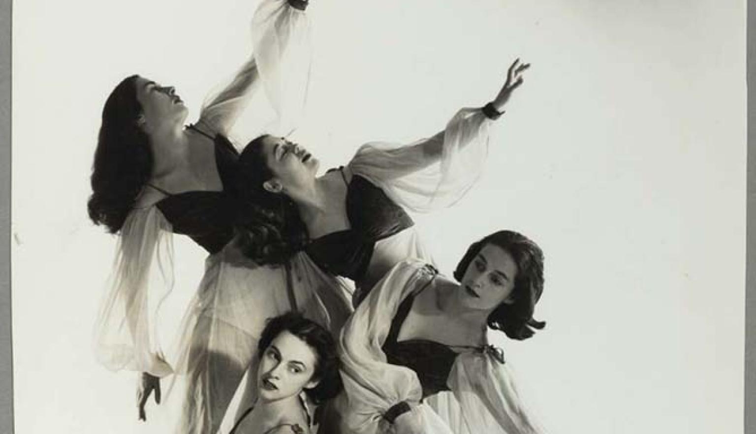 Black and white photo of four women ballet dancers