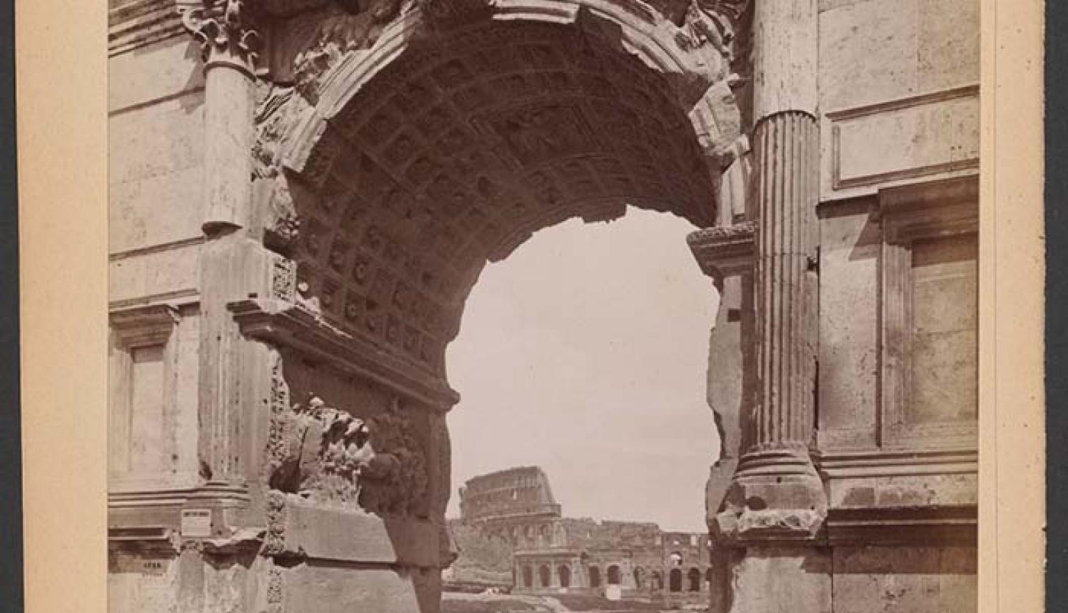 A sepia toned photograph showing the ruins of the Colosseum viewed through the ruins of the Arch of Titus. At the bottom of the photo are words in Italian: 'ROMA - Colosseo, verduto dali Arco di Tito'