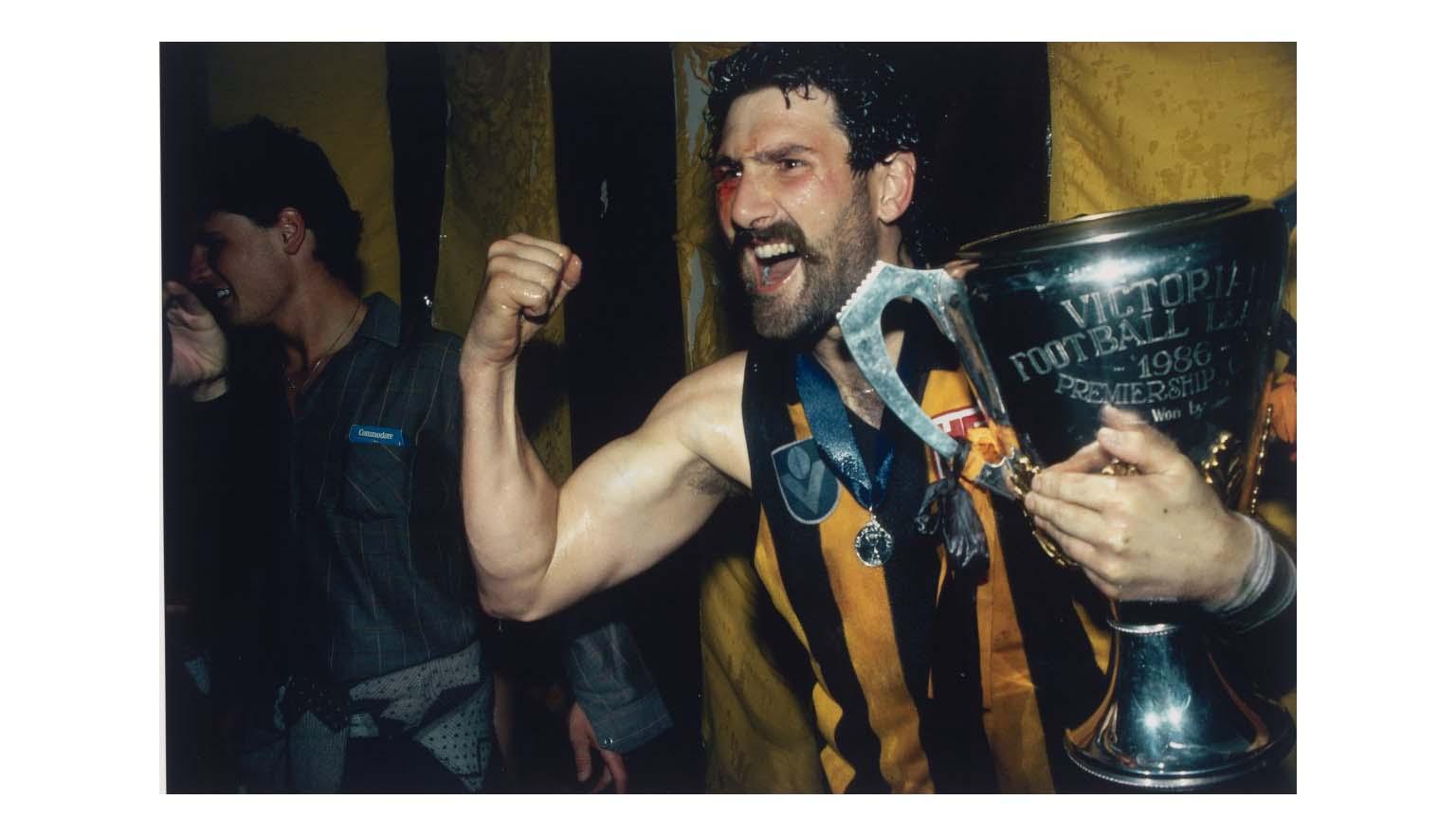 Photo of Robert Dipierdimenico holding a trophy and cheering