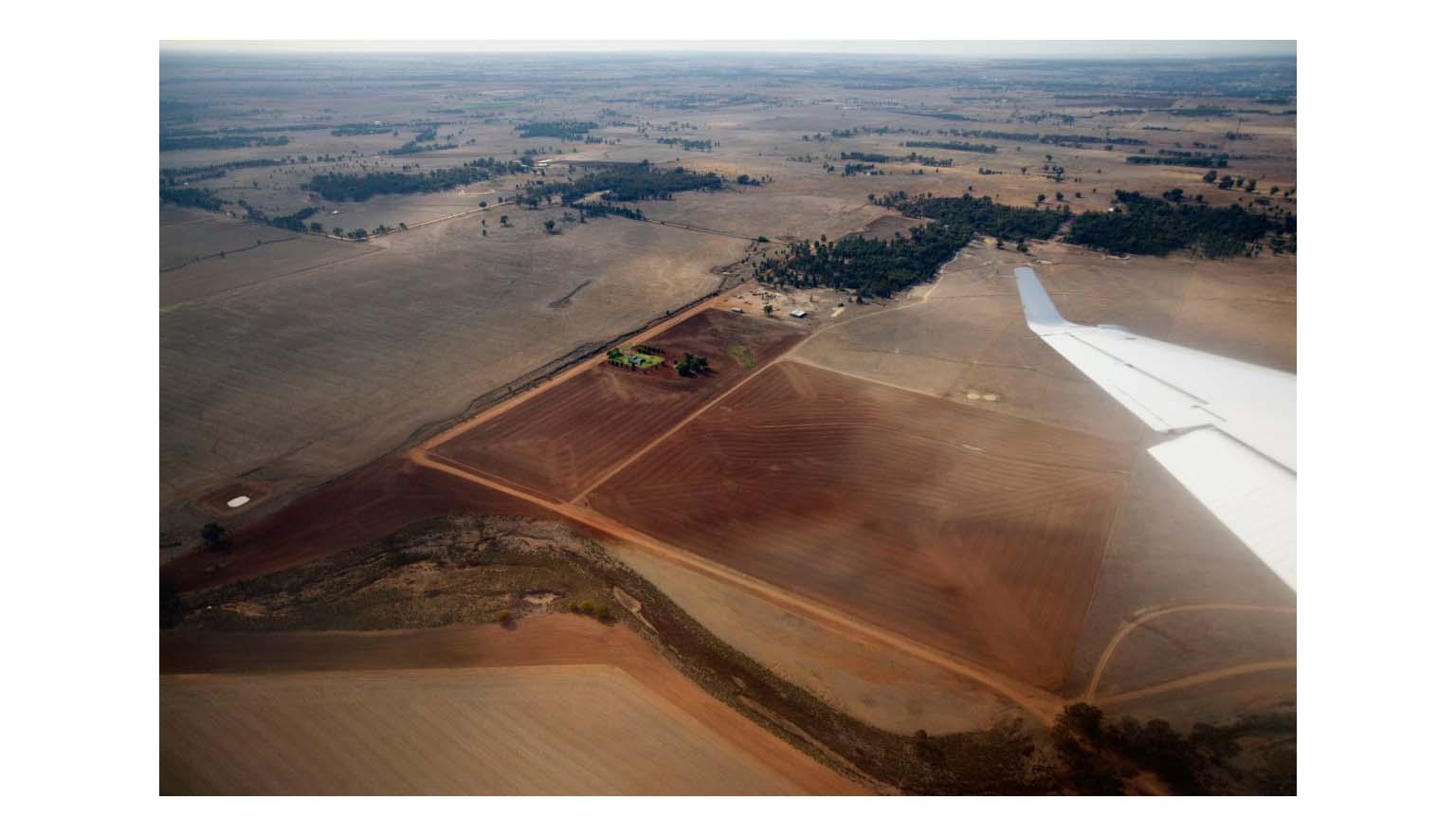 An aerial view of a dry dusty landscape taken from a plane.