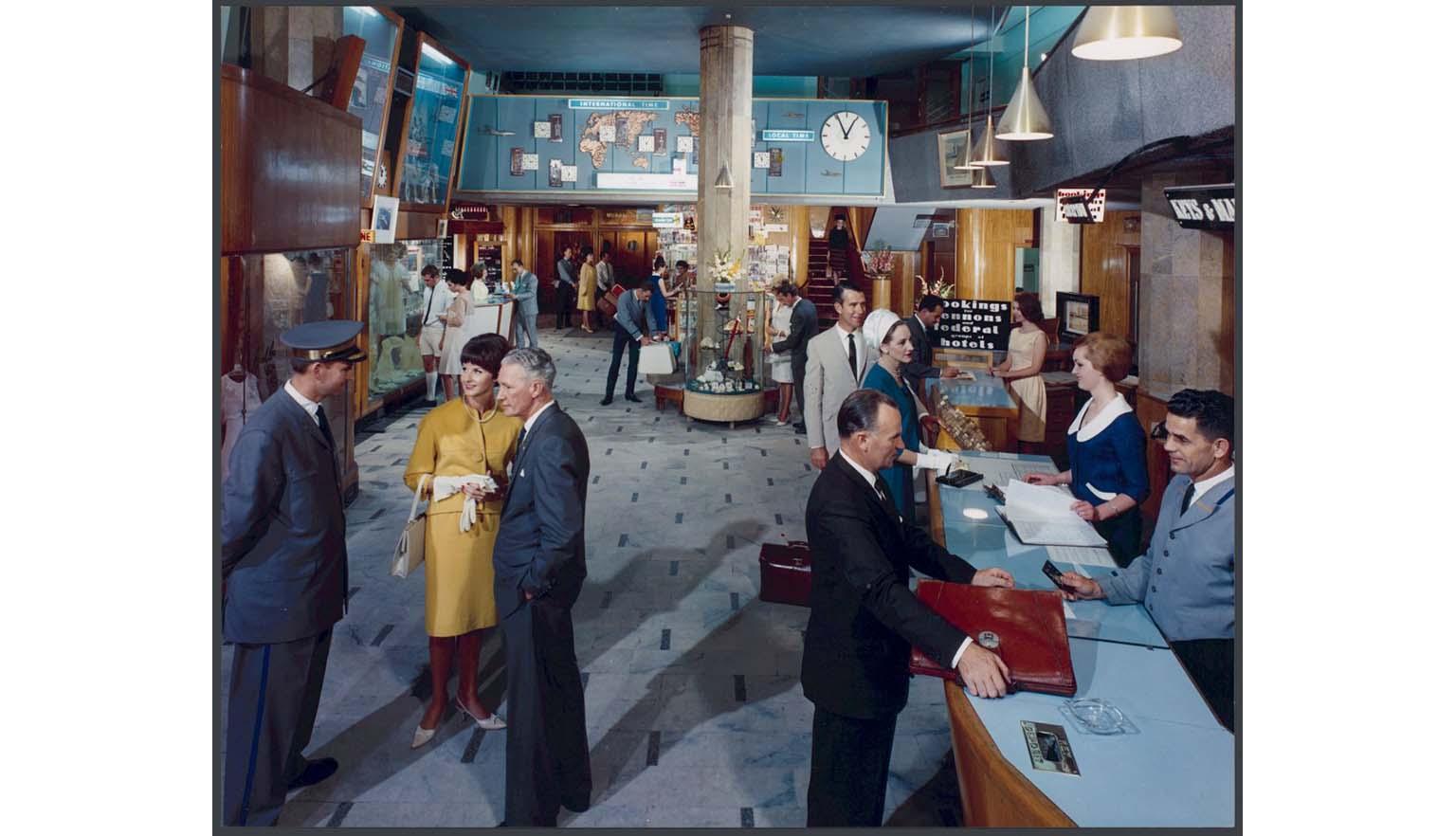 people standing in a hotel reception area, 1965
