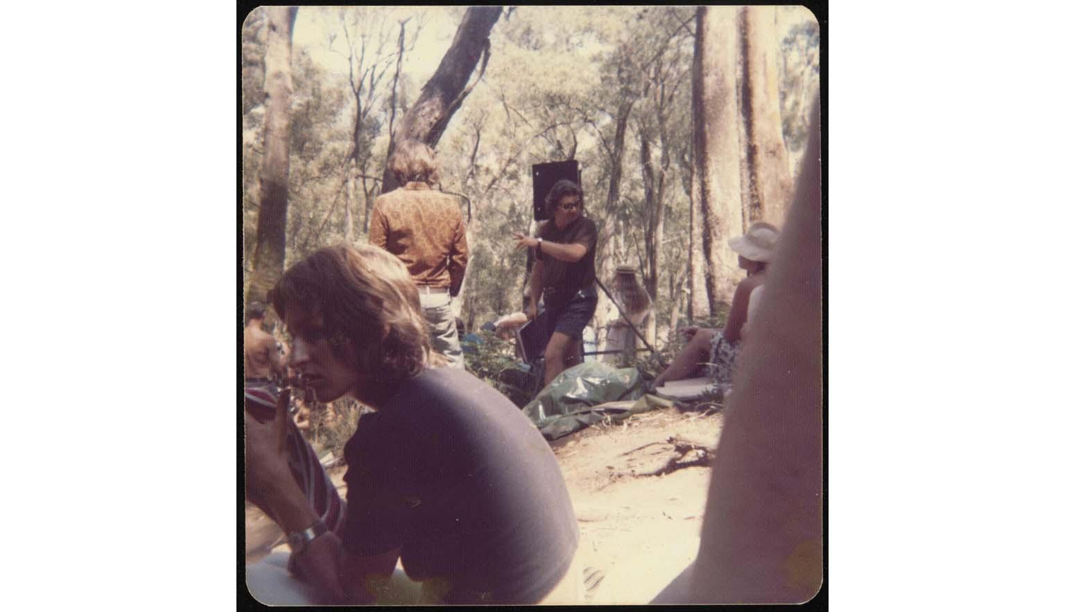 A group pf actors sitting in bushland