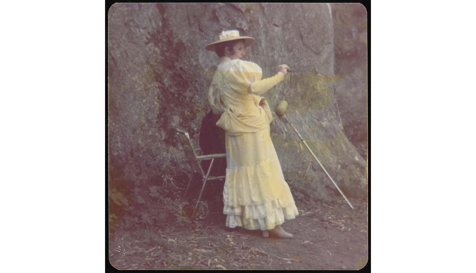 Yellowed photo of woman in white georgian style dress
