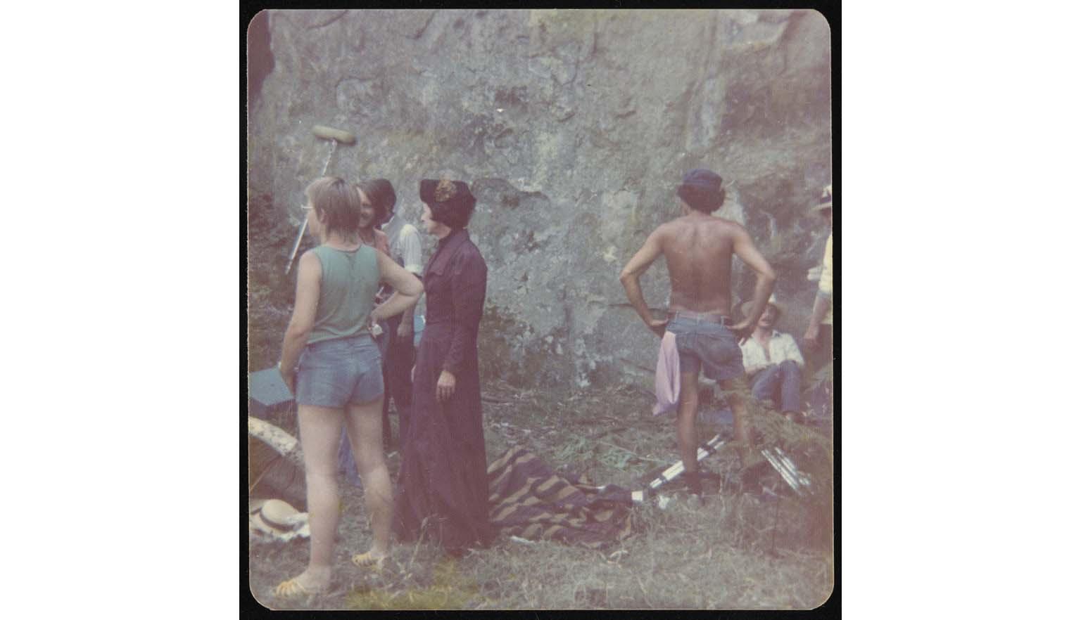 A group of actors gathered at the base of Hanging Rock
