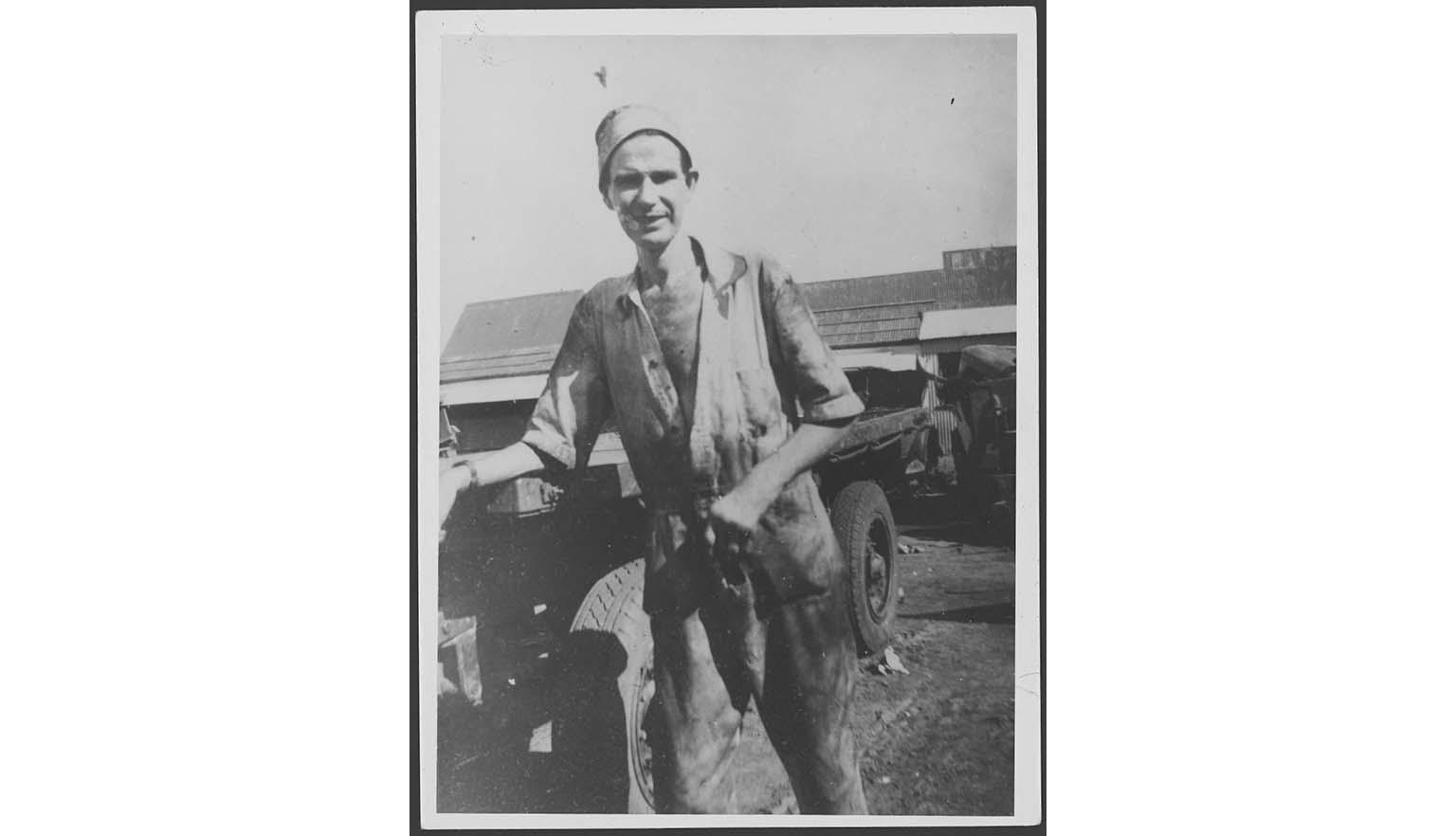 black and white photograph of a man holding an empty bag