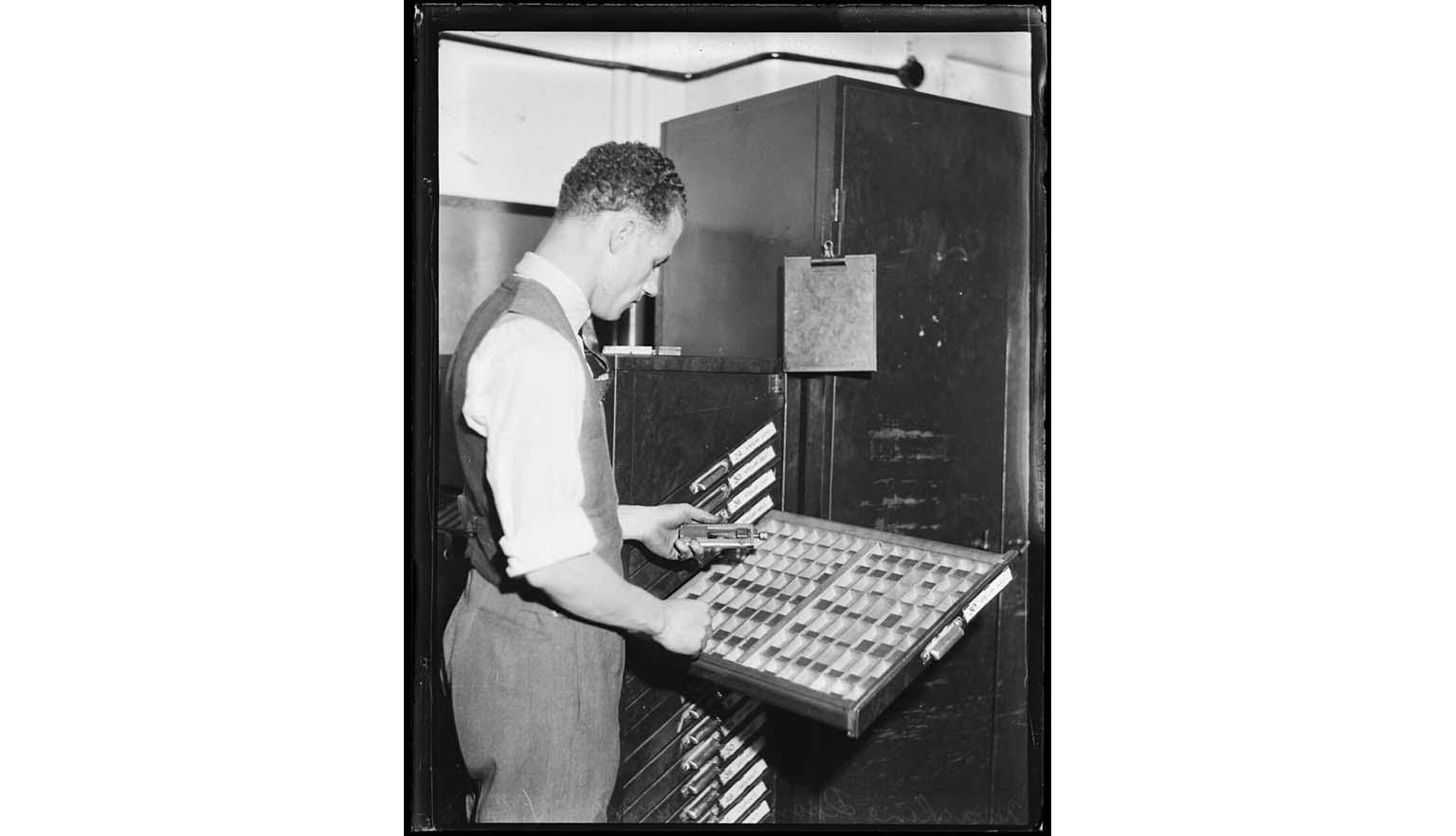 man sorting typefaces, black and white photo