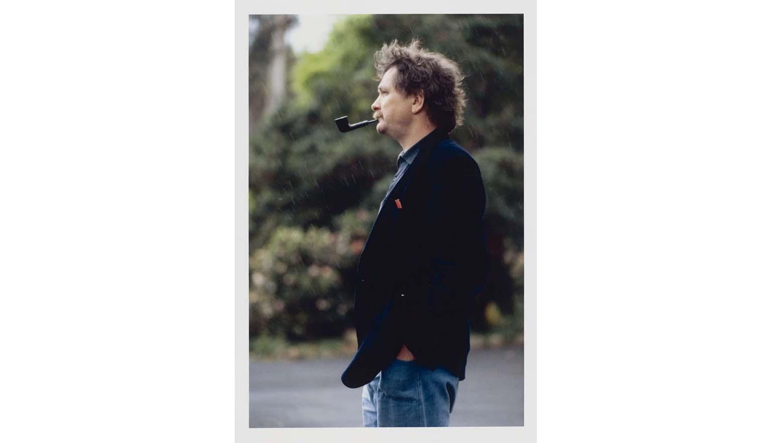colour photograph of man smoking a pipe in profile