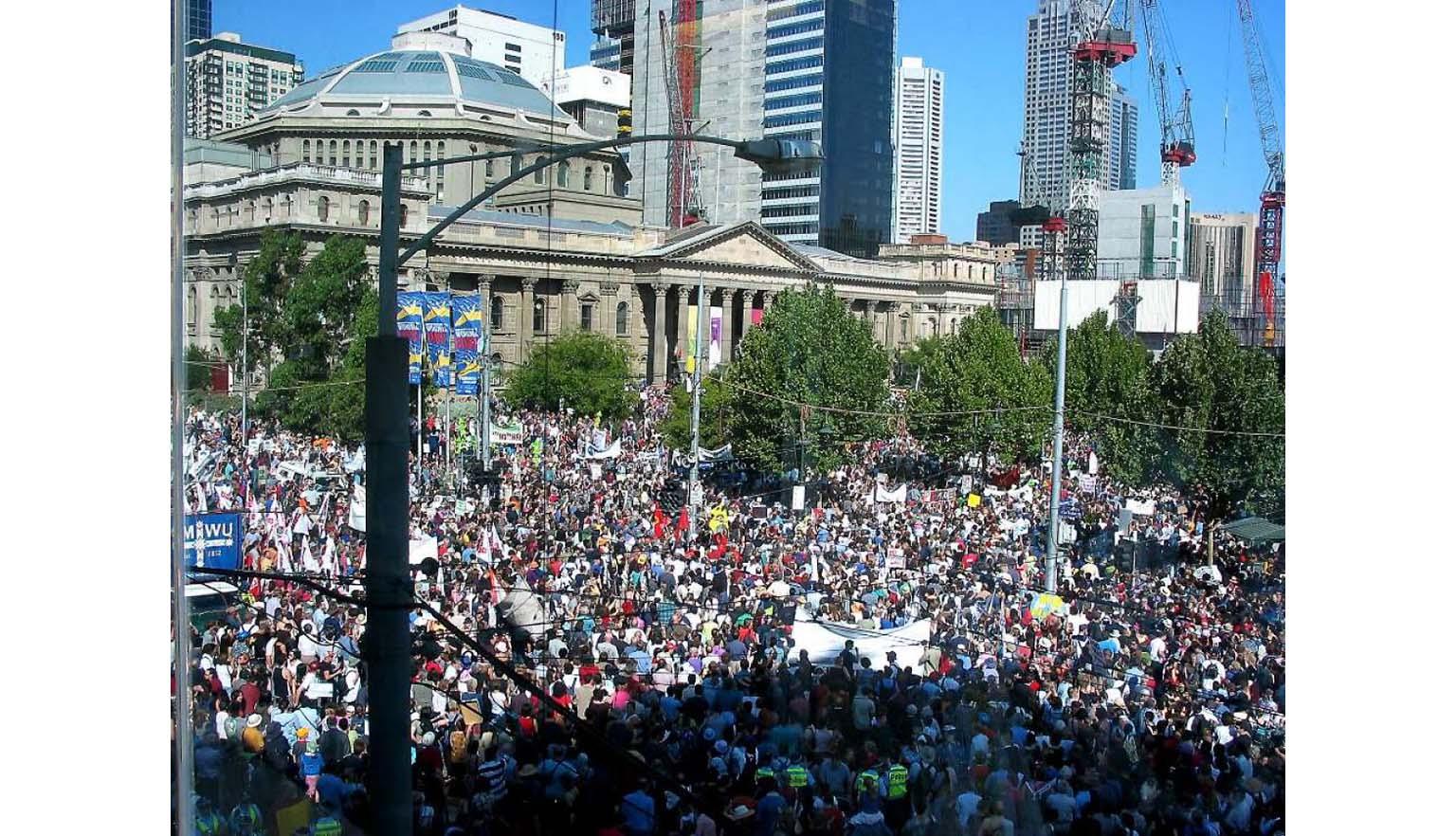 A photo of a large number of protestors gathered in front of the Victorian state library.