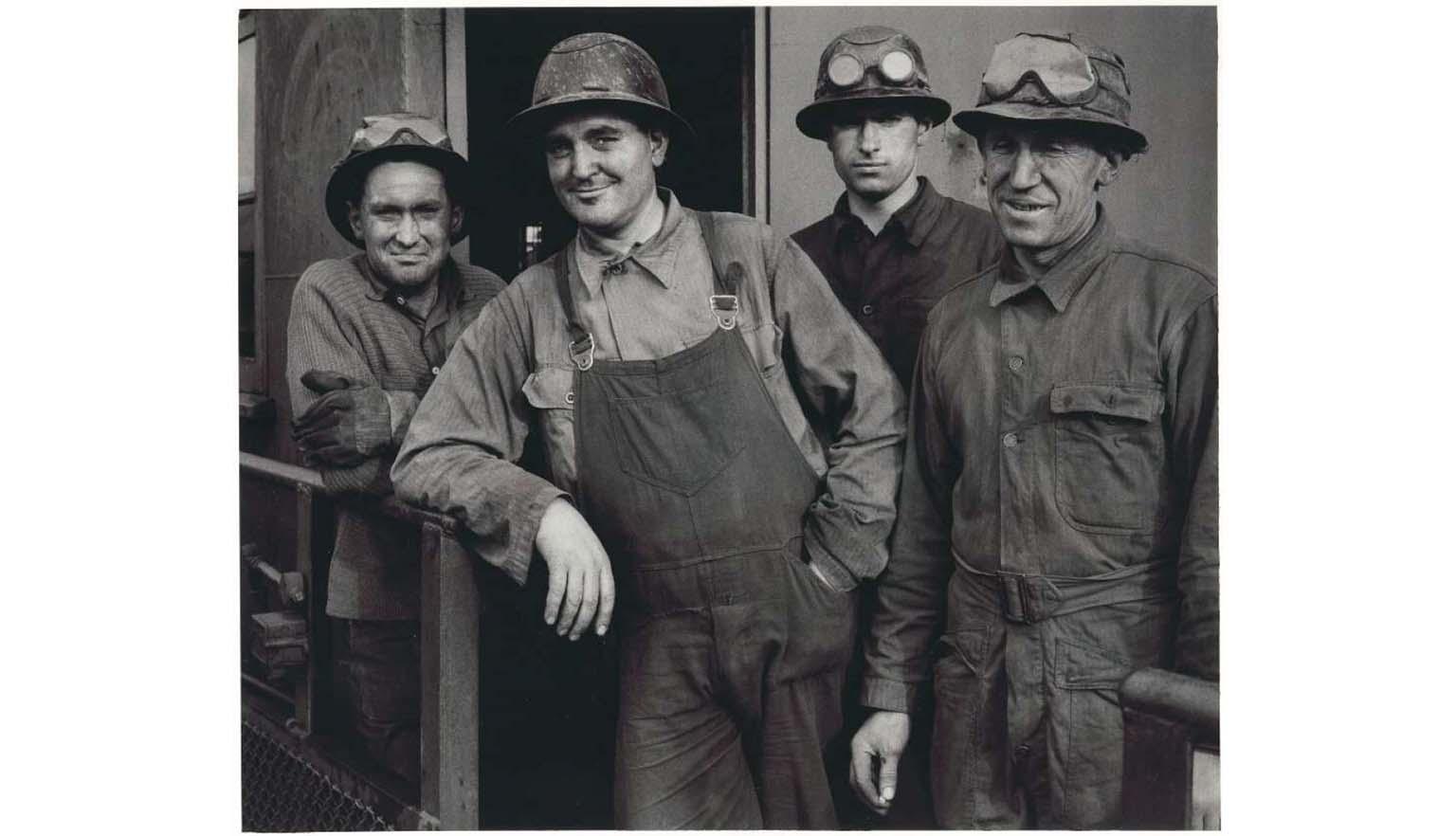 black and white photograph of four miners