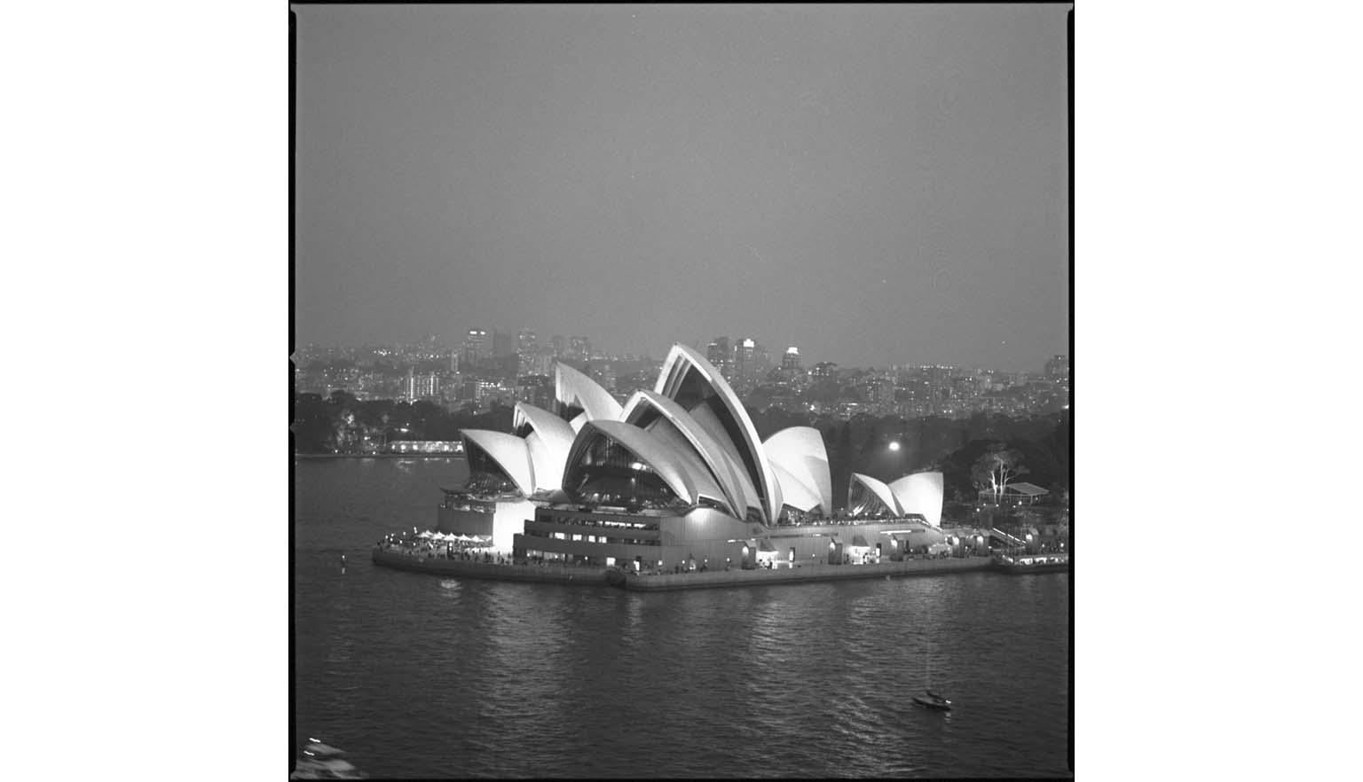 A black and white arial photograph of the Sydney Opera House