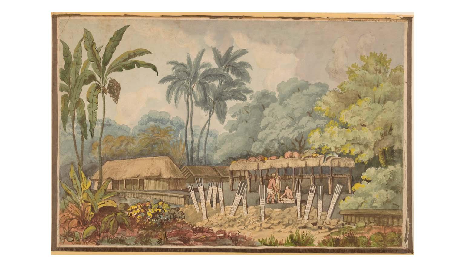 Two men are gathered under the shelter of a thatched roof structure. On top of the structure, offerings of meat and fish are strewn. In the foreground there are twelve signs or totems sticking out of the ground. To the left of the structure is a larger thatched roofed hut. The compound is surrounded by vegetation