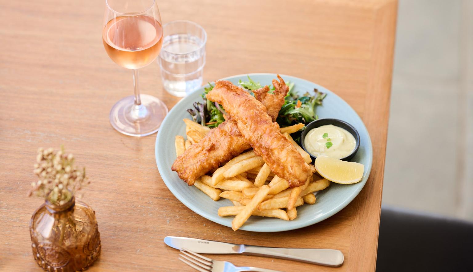 Fish and chips with a glass of rose wine