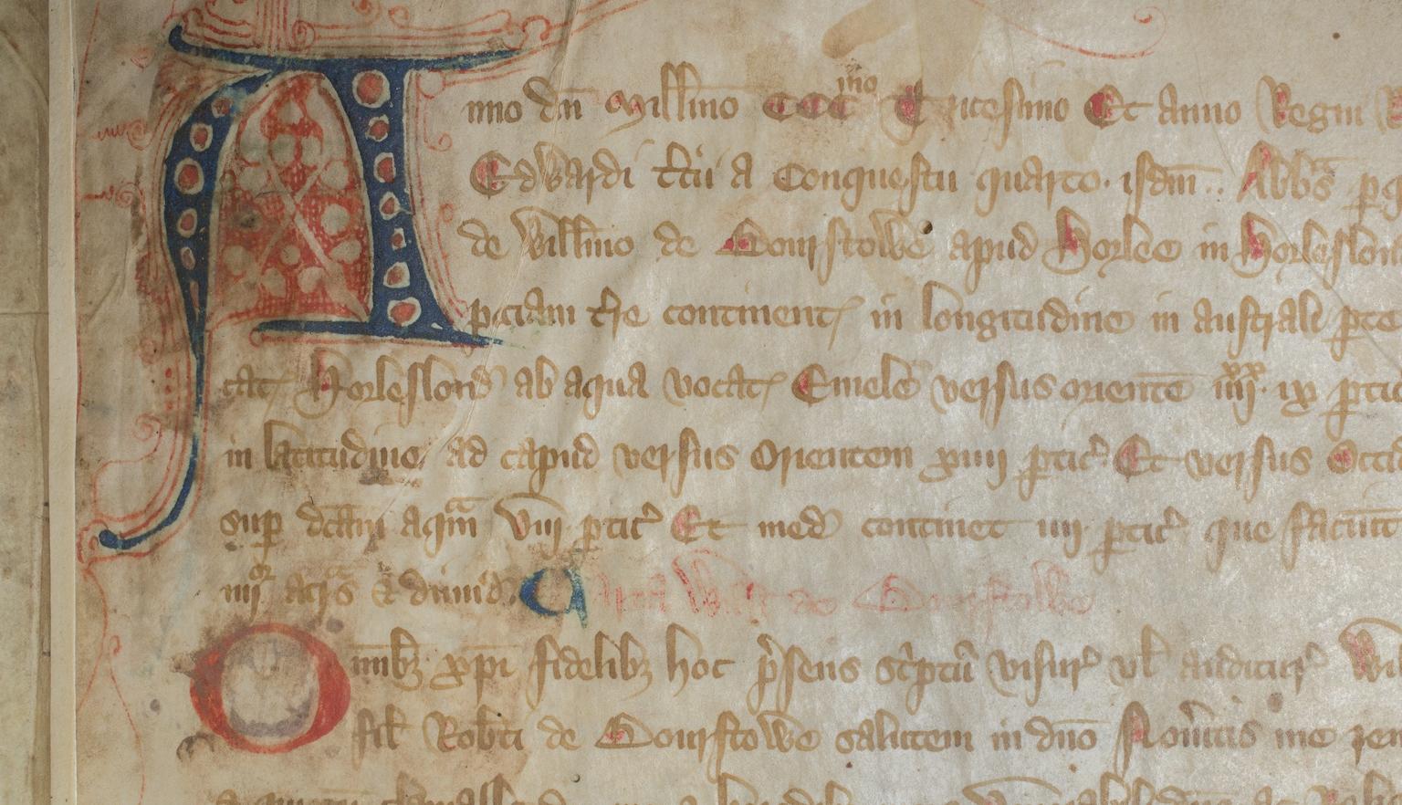 Close up of page of old, rare Latin book with a stylised letter A in the top left