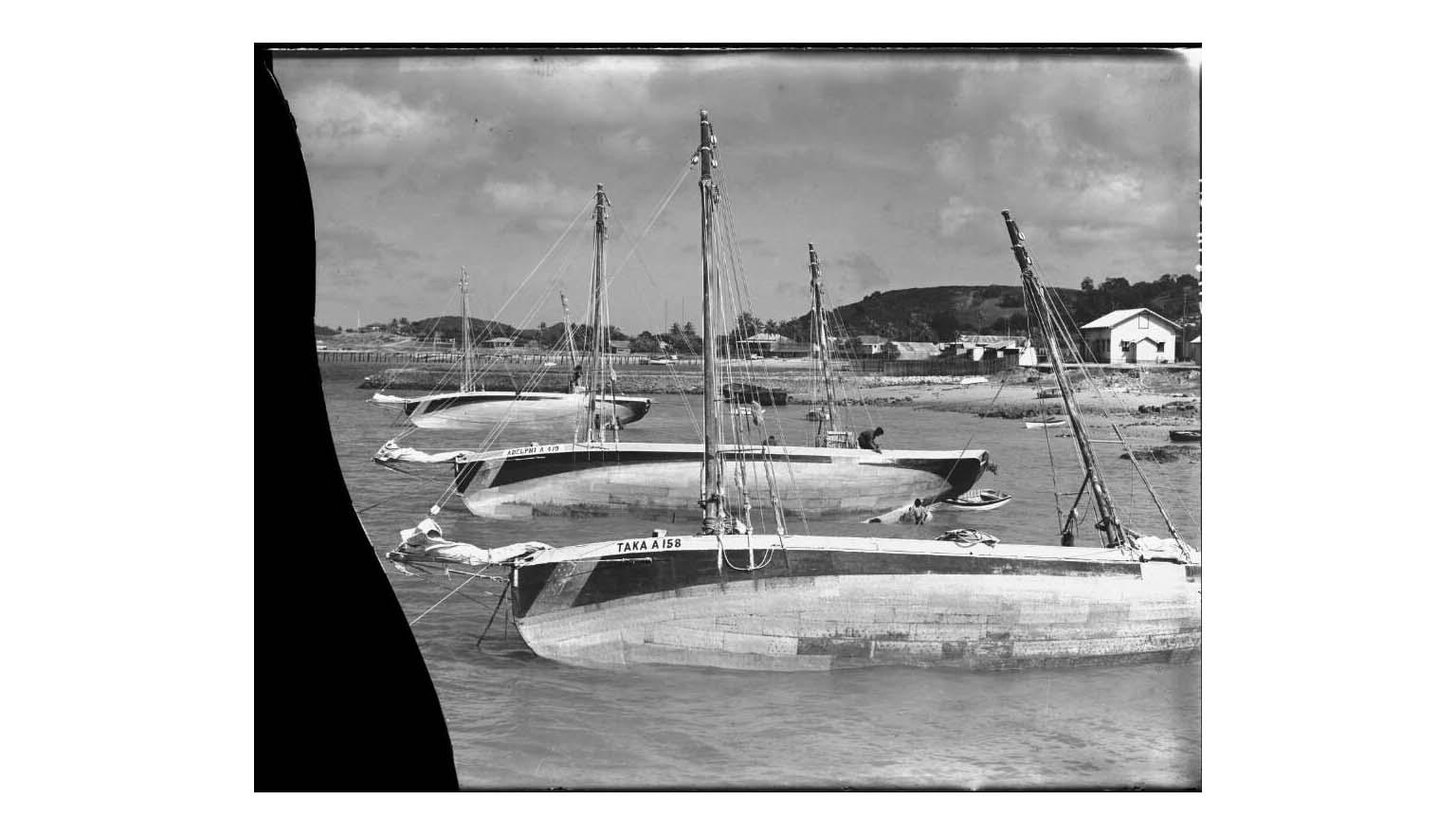 black and white photo of moored pearling boats