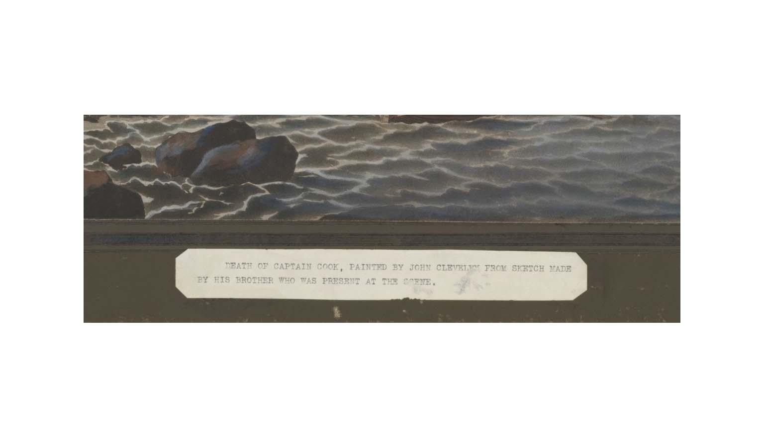 A small paper detail from a larger picture. It has words typed on it by a typewriter. The words say 'Death of Captain Cook, painted by John Cleaveley from sketch made by his brother who was present at the scene'
