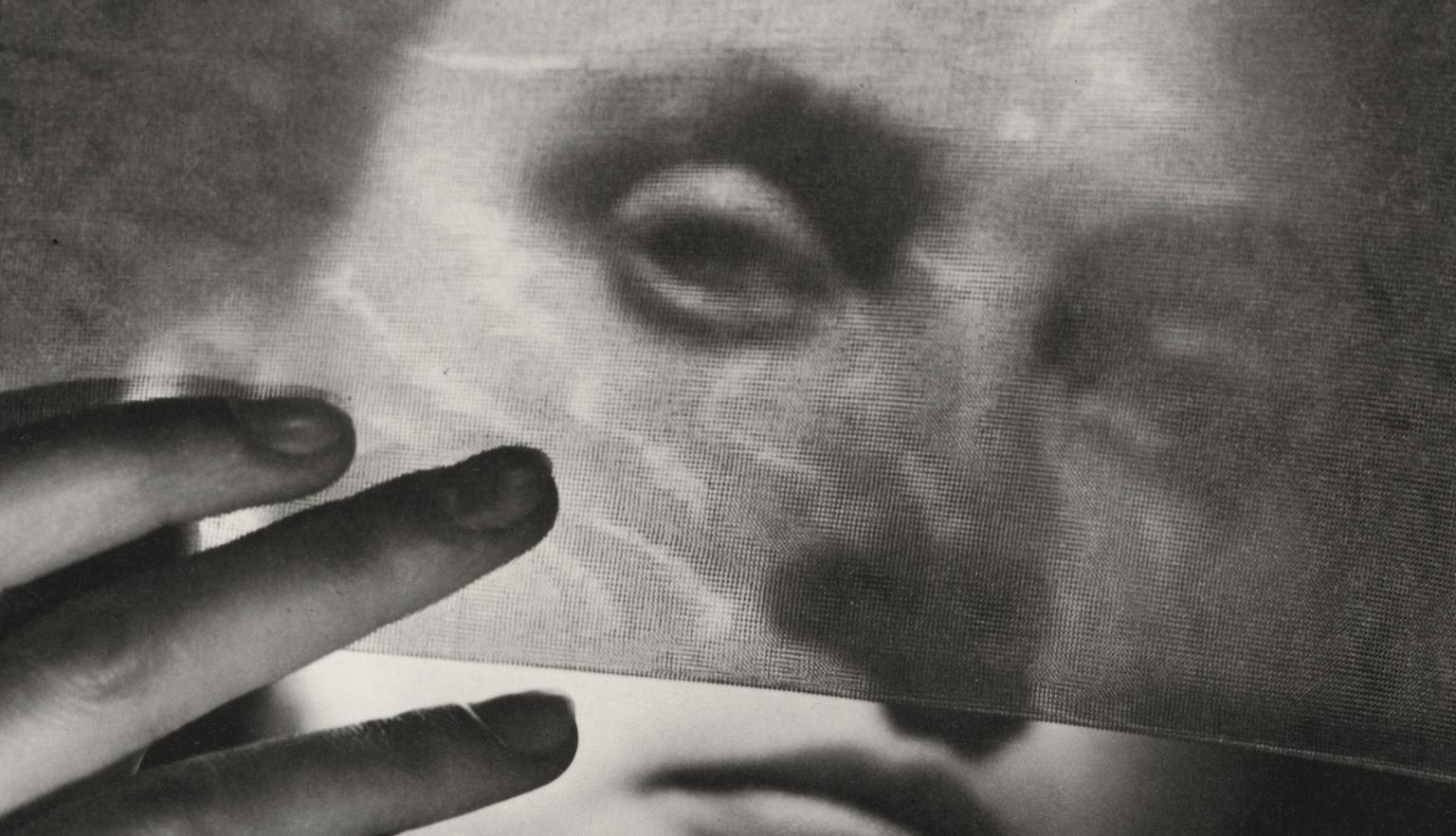 Woman holding up and looking through a sheer stocking