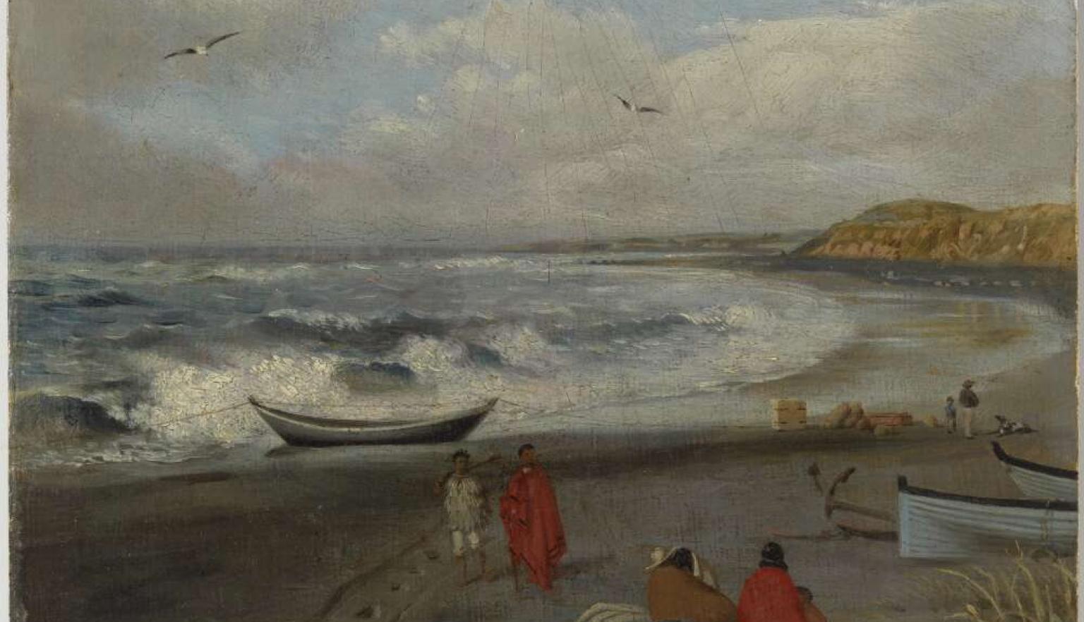 A cloudy day on a beach with a a few poeple siting and talking with another group walking along the beach. 