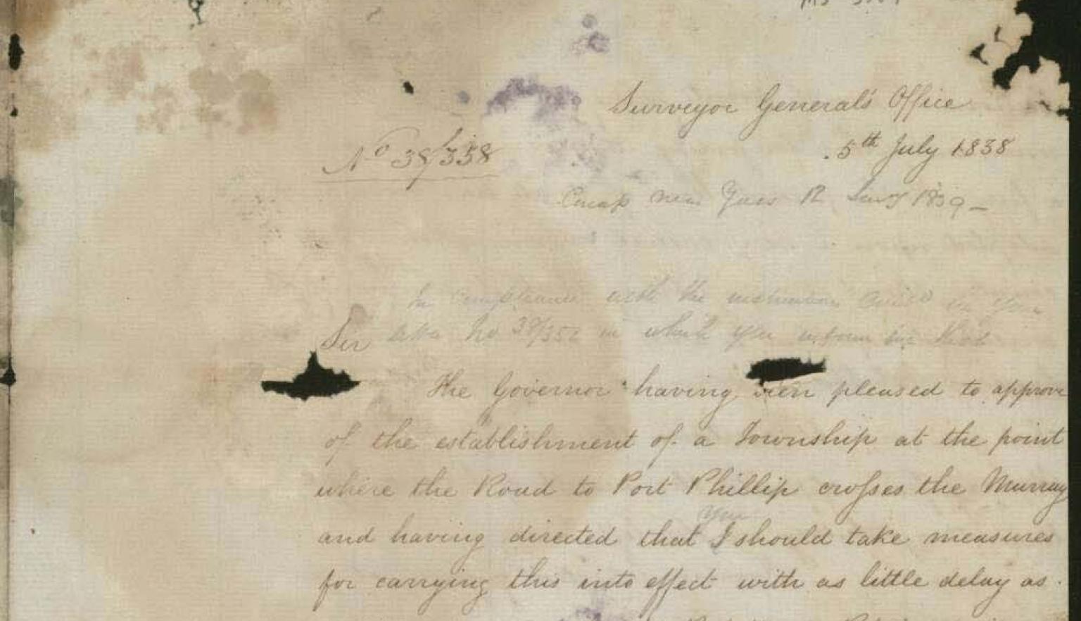 Faded handwritten letter on yellow parchment 