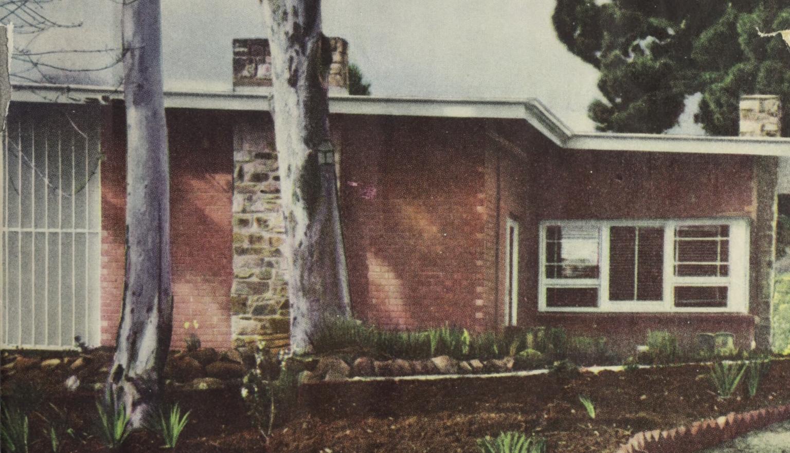 Cover of 'The Australian Home Beautiful' magazine featuring a photo of a red brick house with an angled roof